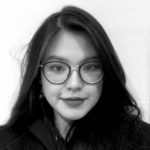 black and white photograph of a woman with long dark hair wearing glasses