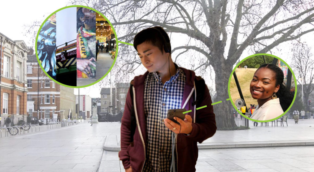 image of a visitor wearing a purple hoodie and checked shirt, holding a phone and listening to the artists voices on the location based audio trail through earphones.
